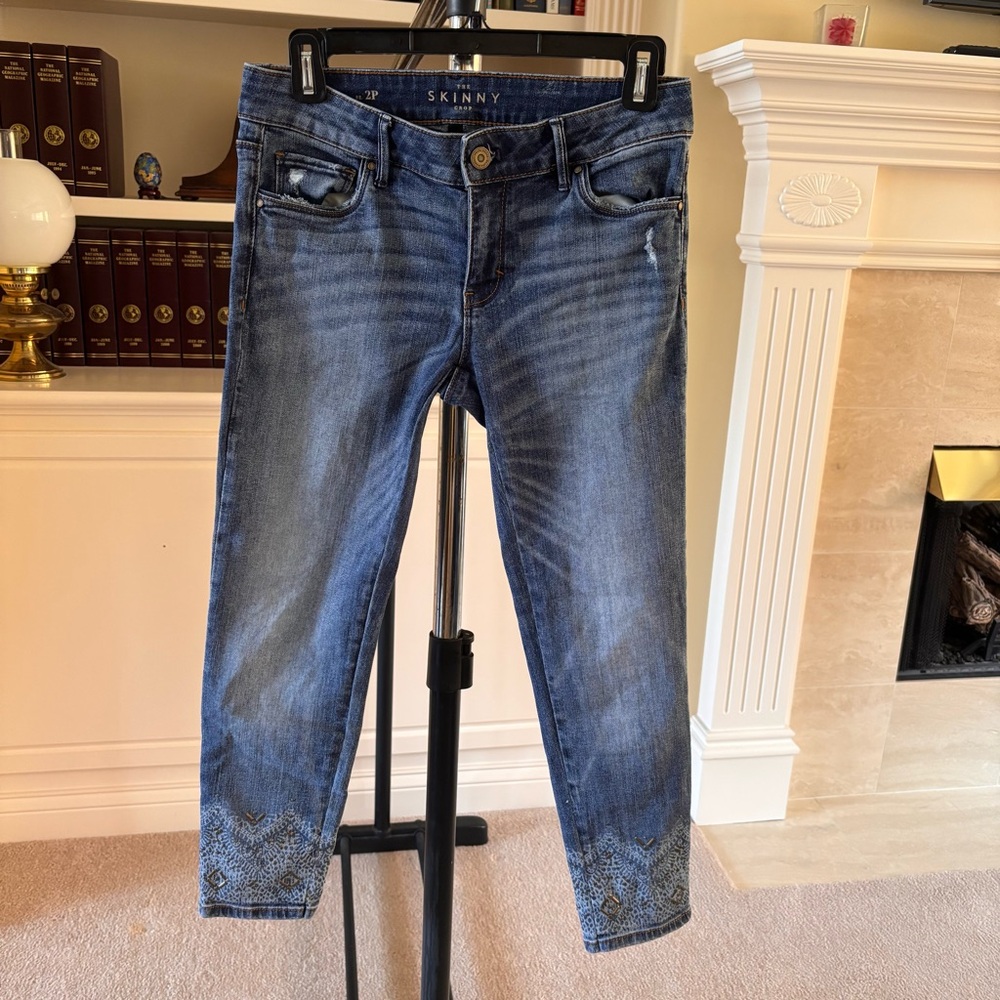 WHBM Women’s ankle straight leg jeans in a light wash with an embroidered cuff